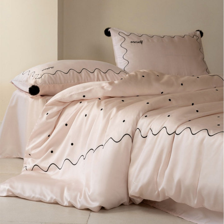 Bedding set made of cotton satin with wavy embroidery edge and pompom cushion