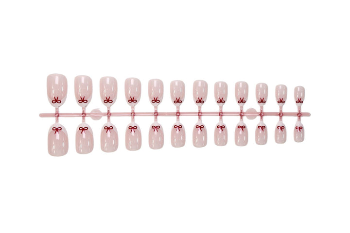 Artificial nail set with romantic bow motifs and French design Stornfield