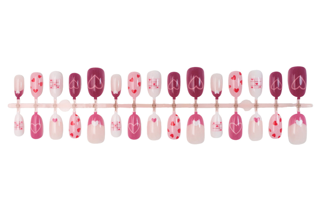 Acrylic nail set with romantic heart motif and creative patterns Stornfield