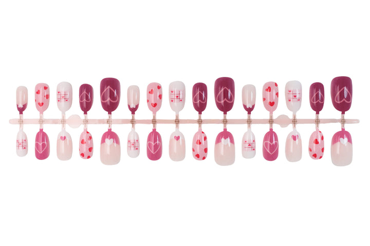 Acrylic nail set with romantic heart motif and creative patterns Stornfield
