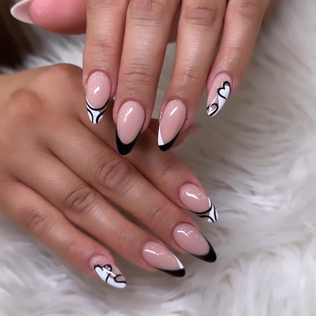 Artful stiletto nails with elegant black-and-white design Stornfield
