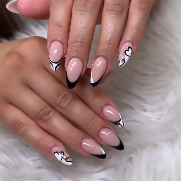 Artful stiletto nails with elegant black-and-white design Stornfield