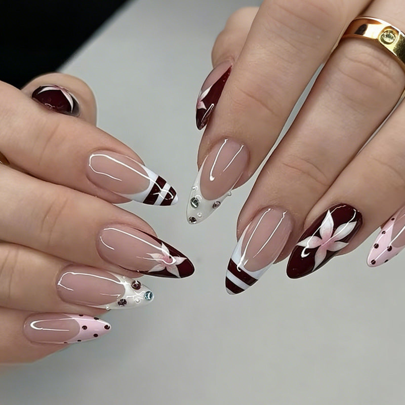 Artificial nail set with floral design and glitter accents Stornfield