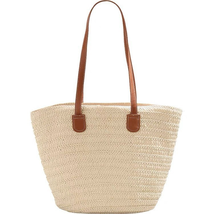 Stylish beach bag made of woven natural material with leather handles Stornfield