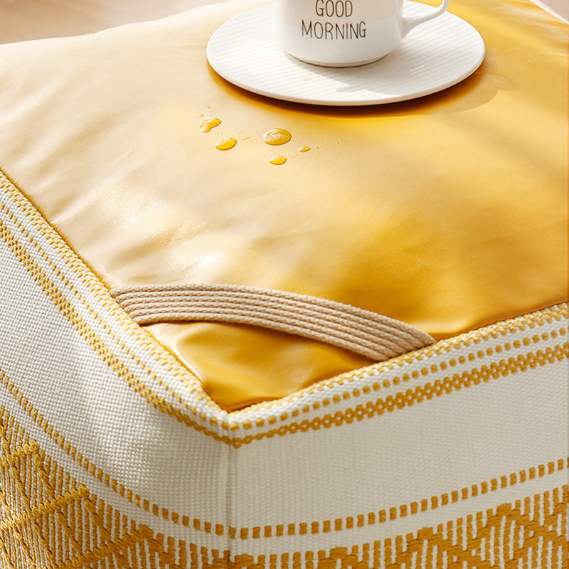 Woven seat pouf with quilted synthetic leather top and carry handle