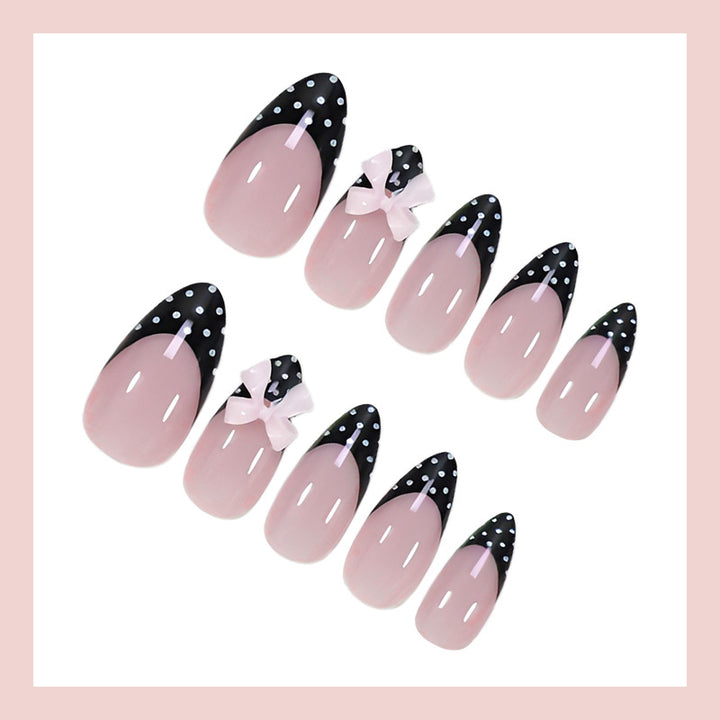 Artificial nail set with glamorous black and white polka dot accents Stornfield