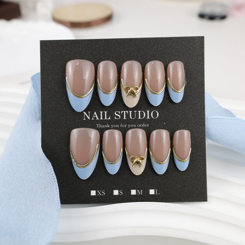 Acrylic nail set with elegant designs and gold accents Stornfield