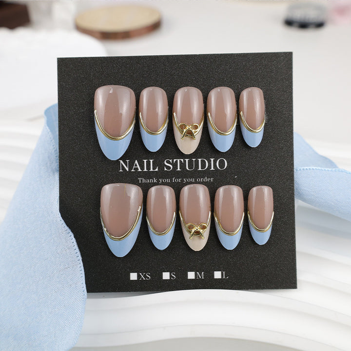 Acrylic nail set with elegant designs and gold accents Stornfield