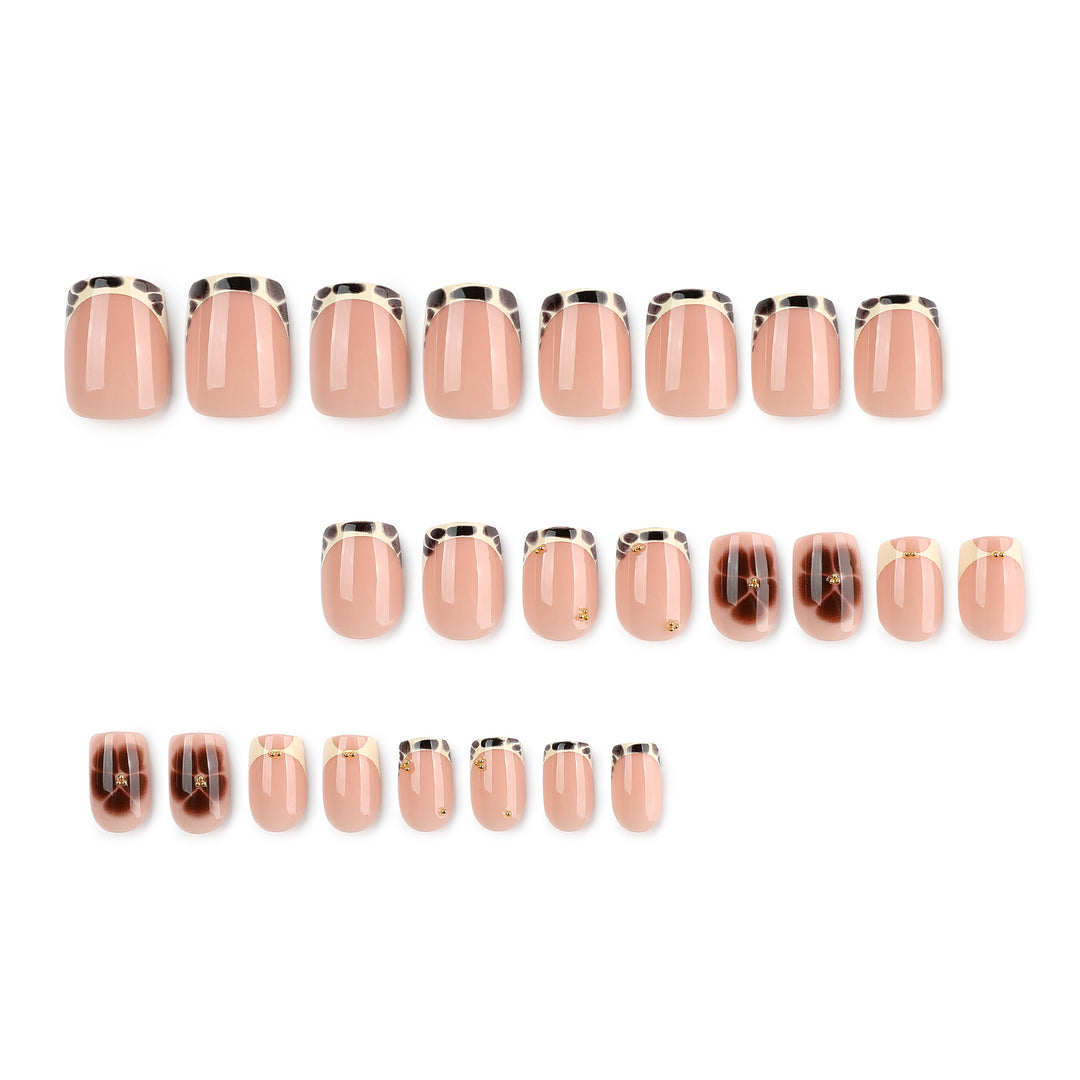 Artful nail extensions with an elegant giraffe pattern and golden accents Stornfield