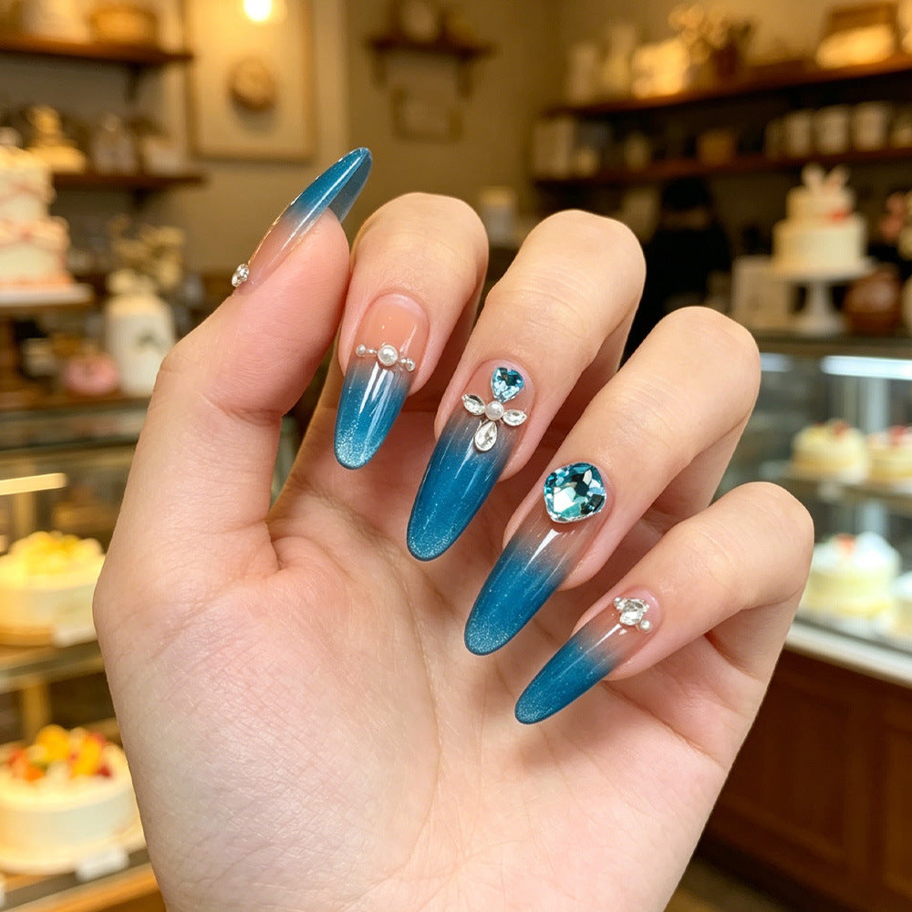 Artificial nails with glitter and rhinestone embellishments Stornfield