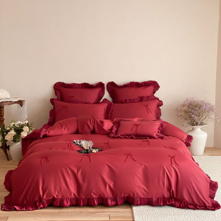 Satin bedding set with ruffle edges, delicate bow appliqué and pillowcases