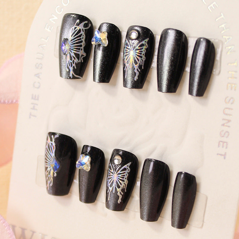 Artificial nails with decorative butterfly designs and glitter accents Stornfield