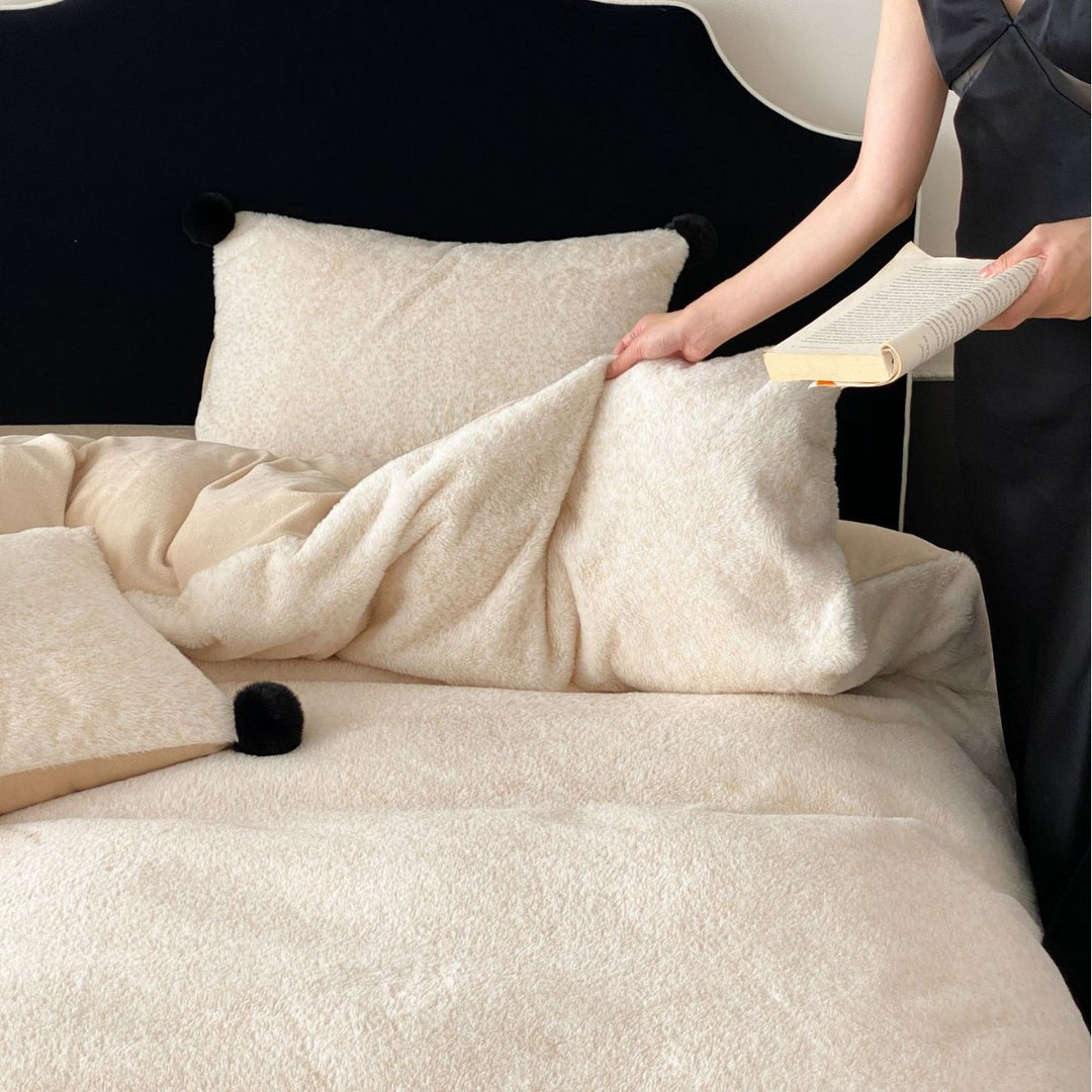Bedding set made of soft cotton blend with decorative pom poms and reversible back
