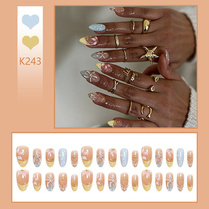 Artificial nail set with floral motifs and glitter accents Stornfield