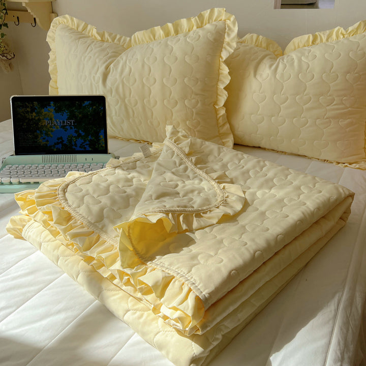 Quilted bedspread set with frill edge and heart quilting pattern
