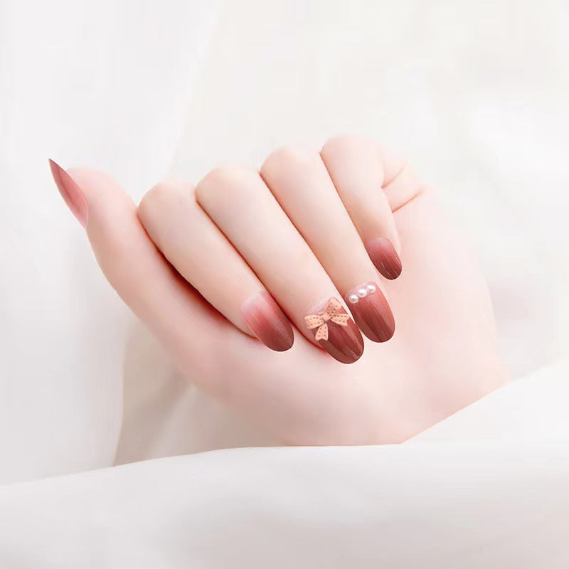 Artificial nails with glamorous bow and pearl decor Stornfield