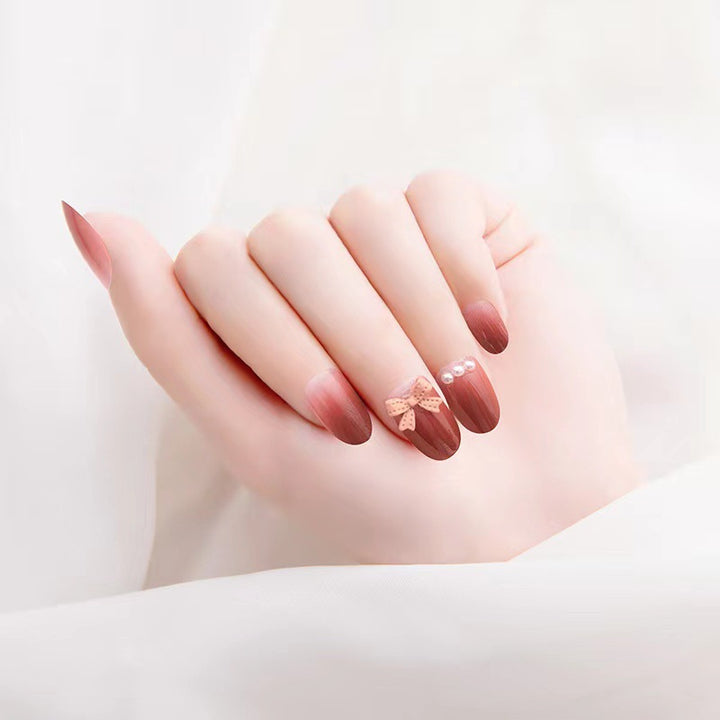 Artificial nails with glamorous bow and pearl decor Stornfield