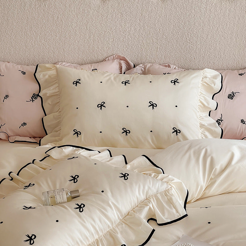 Exclusive bedding set in romantic style with ruffle, subtle bow embroidery, and breathable cotton satin