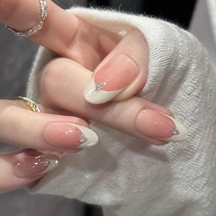 Artificial nails with elegant French style and sparkling accents Stornfield