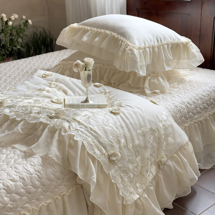 Romantic bedding set with quilted bedspread, ruffled pillow and floral embroidery