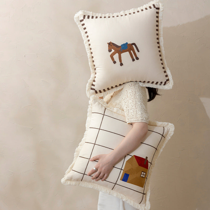 Decorative cushion cover made of cotton blend with fringes, check pattern and embroidered house Stornfield