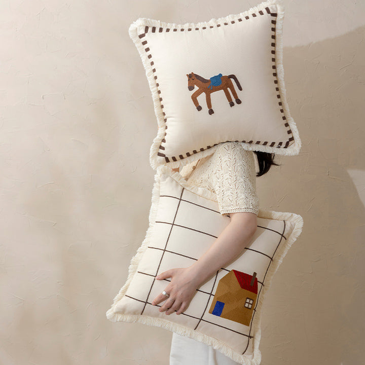 Decorative cushion cover made of cotton blend with fringes, check pattern and embroidered house Stornfield