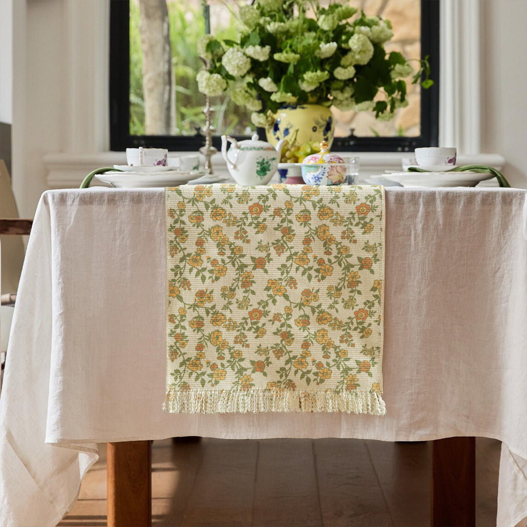 Woven table runner with flower jacquard, fringes and cotton blend
