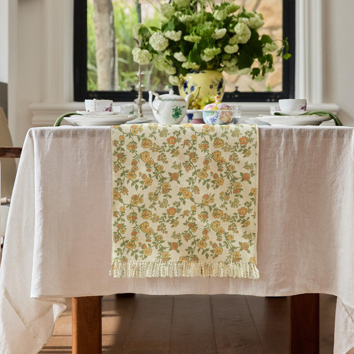 Woven table runner with flower jacquard, fringes and cotton blend