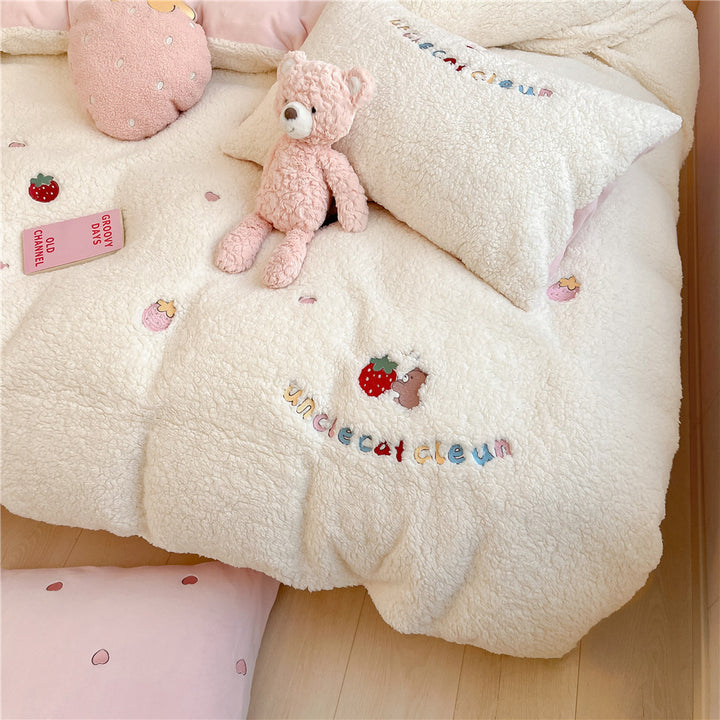 Plush quilt with teddy fleece, embroidered strawberry appliqués and reversible function