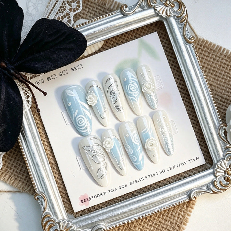 Artificial nail set with elegant floral motifs and glitter effects Stornfield