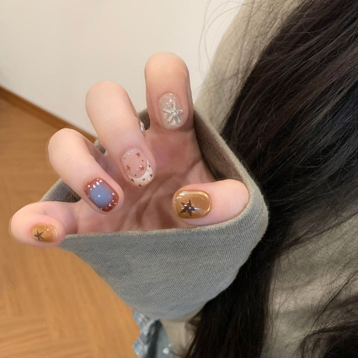 Artificial nails in modern design with star and gradient elements Stornfield