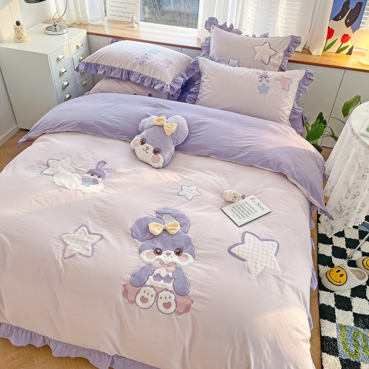 Children's bedding set with plush appliqués, ruffled flounces, and embroidery