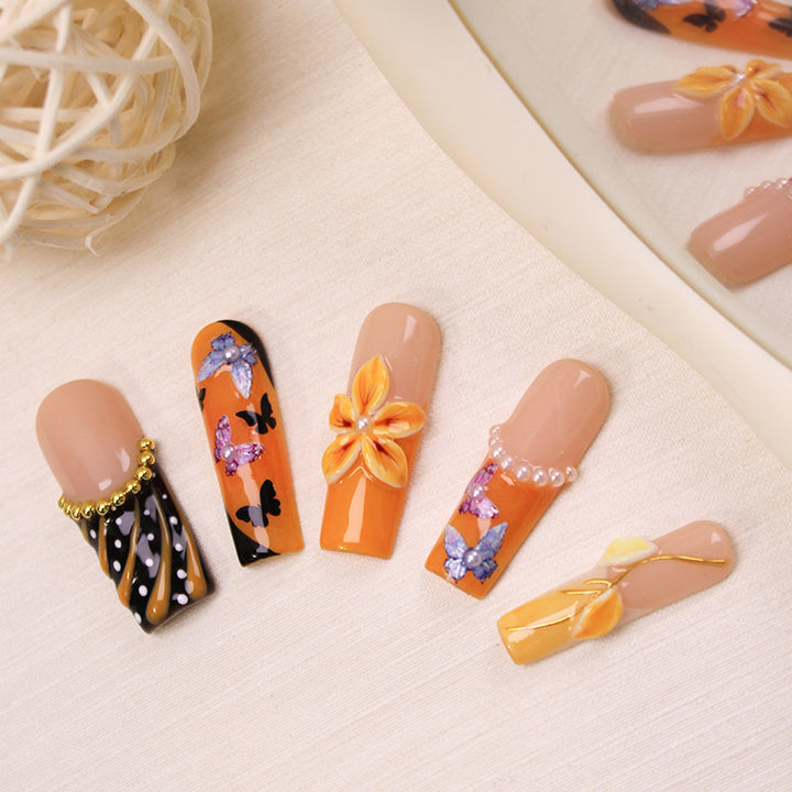 Artificial nail set with elegant flower and butterfly designs Stornfield