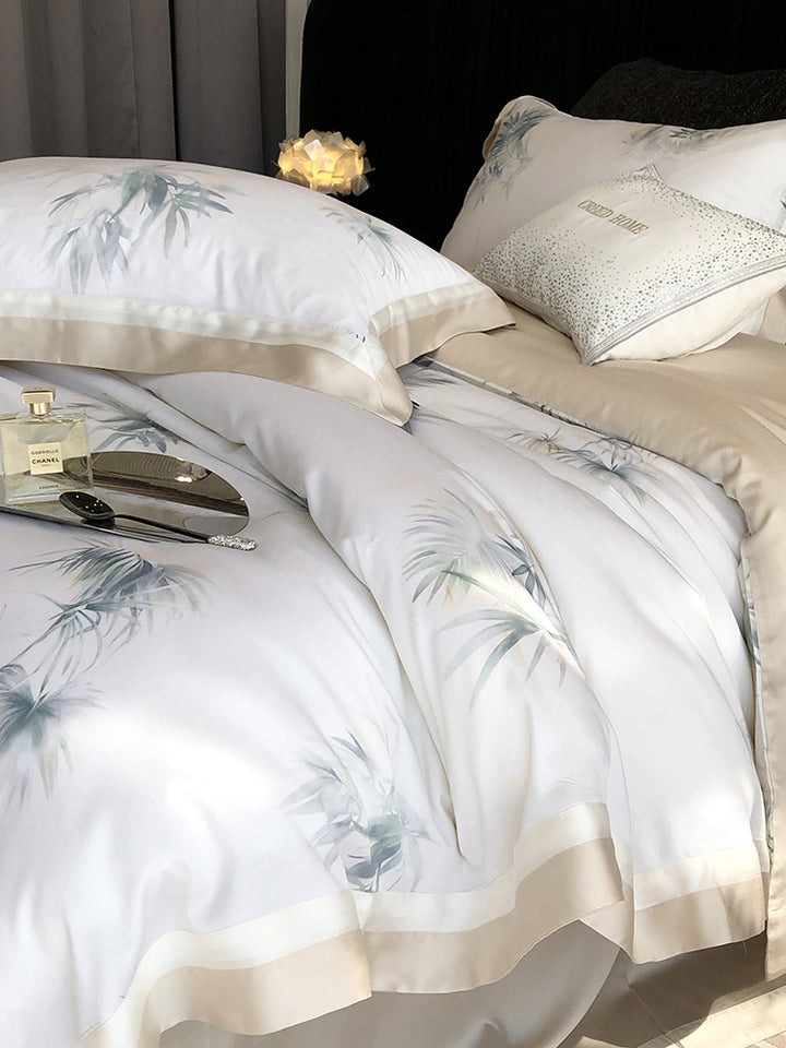 Luxurious cotton satin bedding set with delicate leaf print, contrasting hem and fine piping