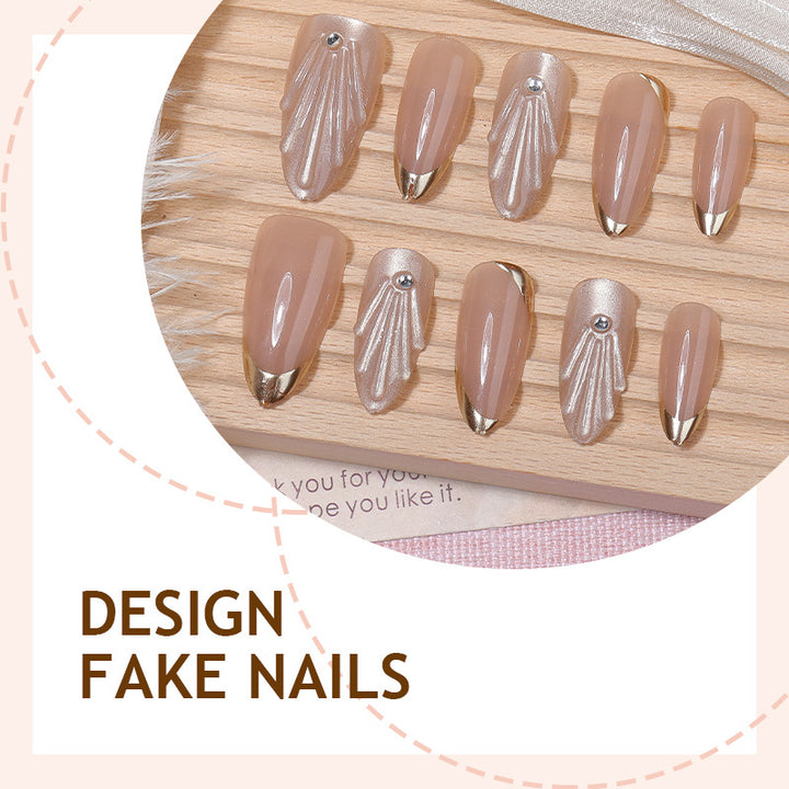 Artificial nail set with elegant gold tips and artistic decorations Stornfield