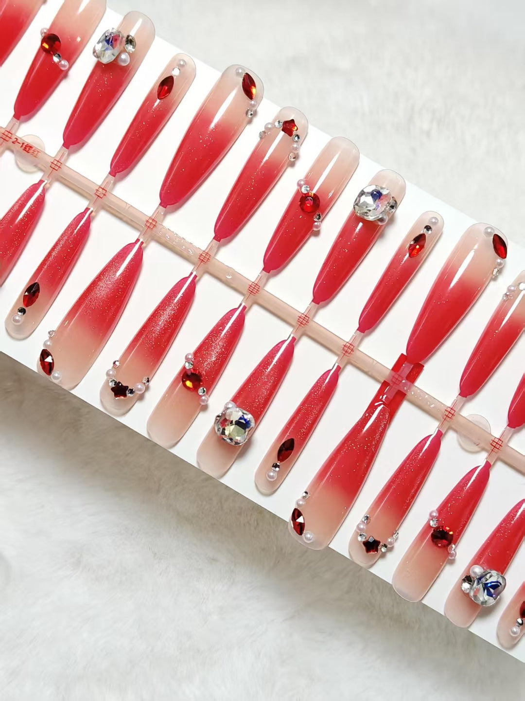 Artificial nails with glamorous glitter and rhinestone embellishments Stornfield