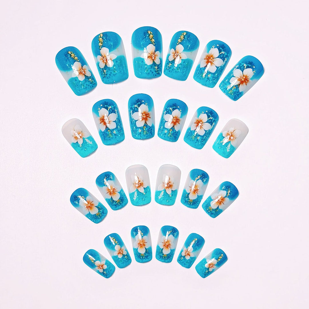 Artificial nails with floral accents and glitter patterns Stornfield