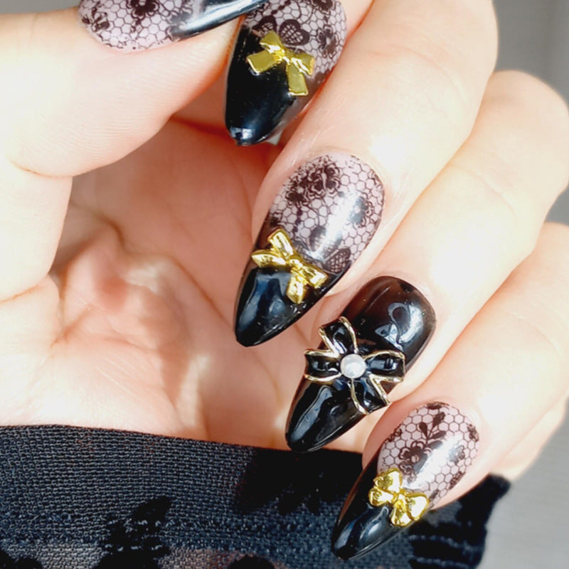 Artificial nail set with elegant dot and bow decorations Stornfield