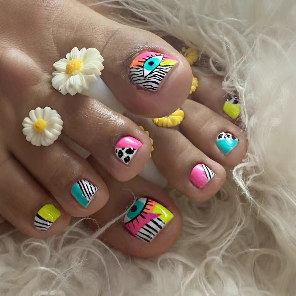 Artificial nail set with vibrant color accents and geometric patterns Stornfield