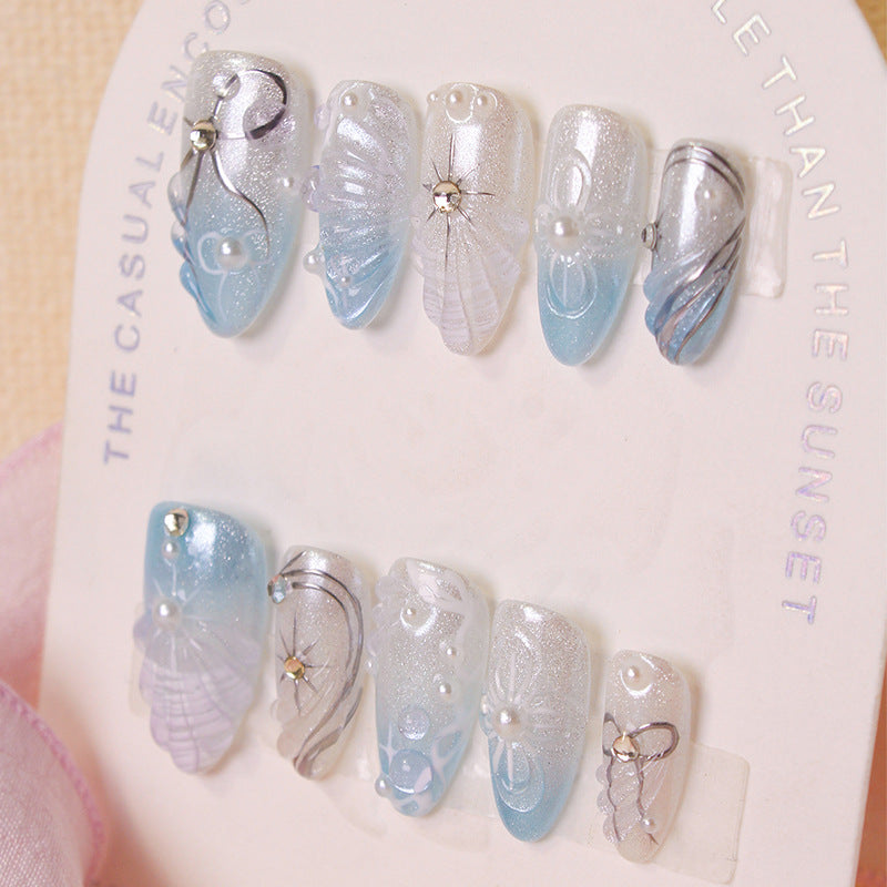 Artificial nail set with elegant shell and pearl accents Stornfield