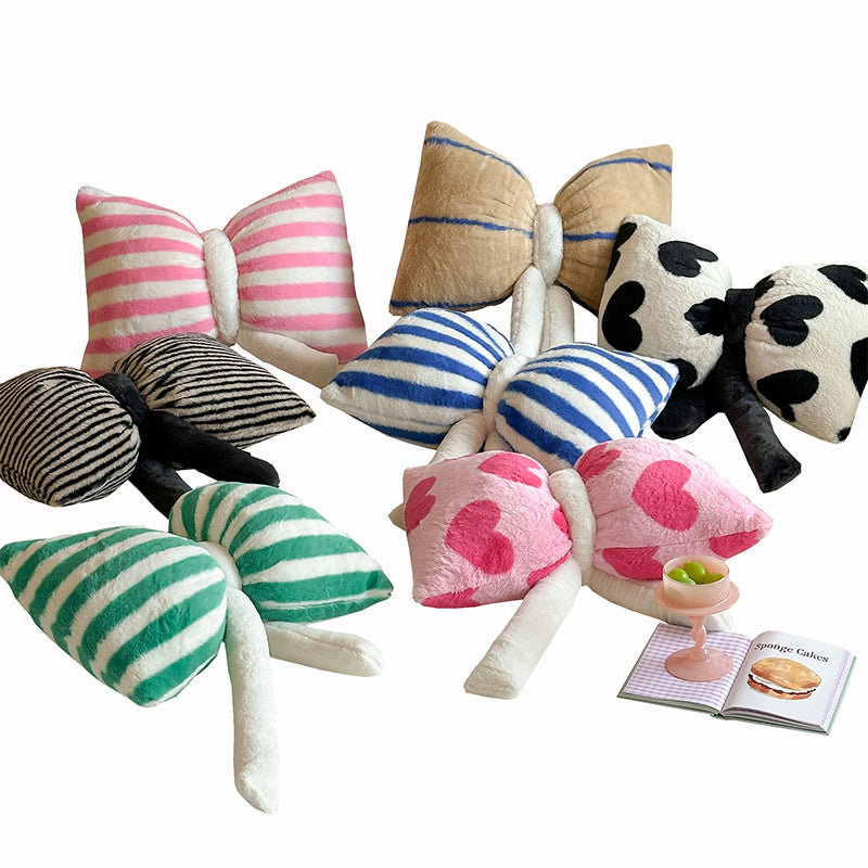 Cuddle cushion in bow shape made of plush with striped texture