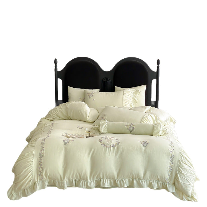 Premium bed linen set made of cotton percale with fine ruffle trim and embroidered calla motifs