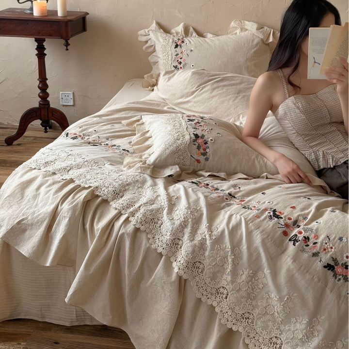 Romantic bedding set in country house style with embroidered border, frill and lace appliqué