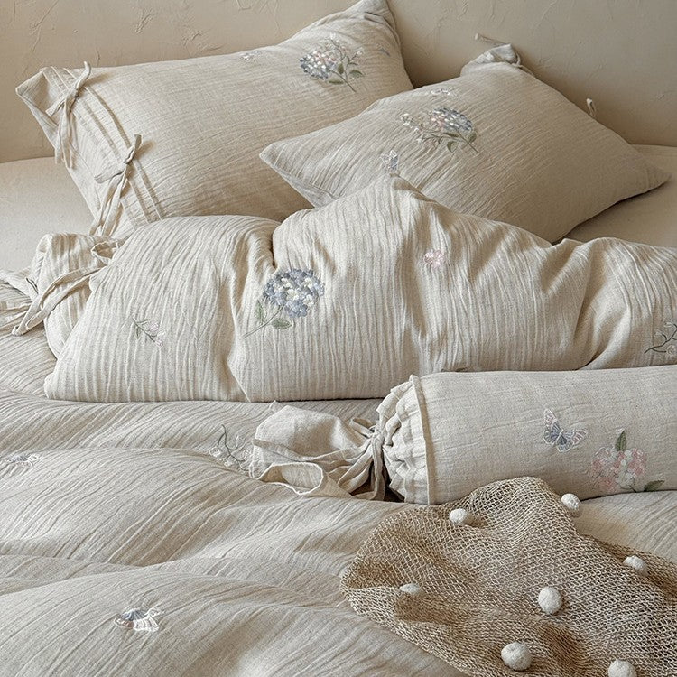 Embroidered cotton-linen bedding set with decorative ribbons and fine floral design