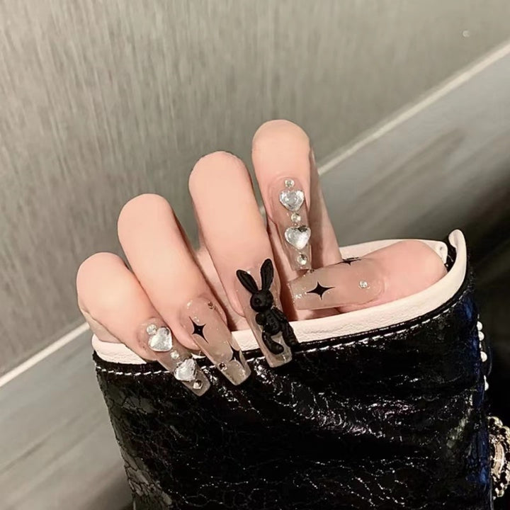 Artificial nails with glitter accents and playful motifs Stornfield