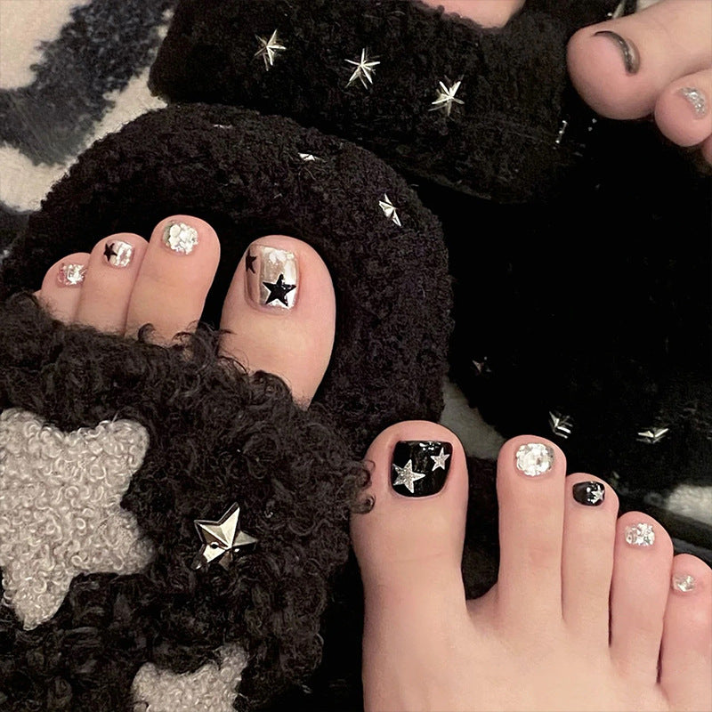 Artistic toenail art with rhinestone and glitter elements Stornfield