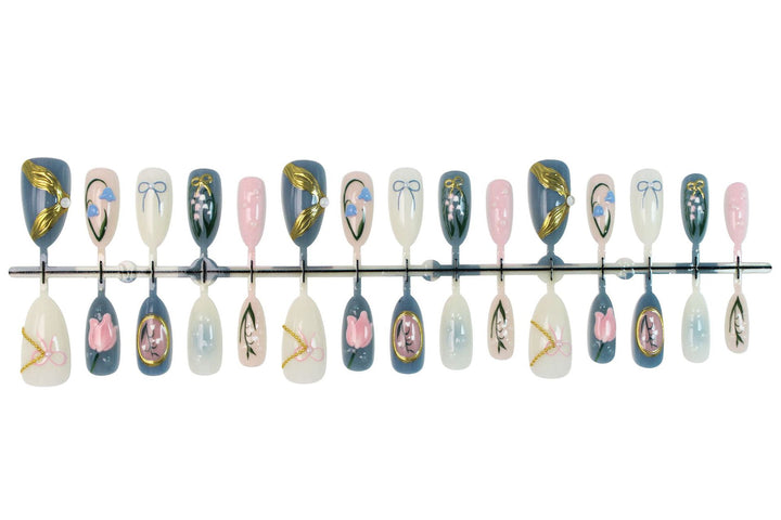Acrylic nail set with floral design and elegant gold embellishments Stornfield