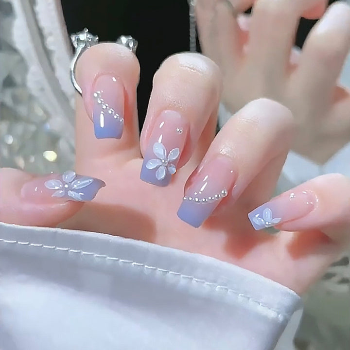 Nail set with elegant floral accents and glitter embellishments Stornfield