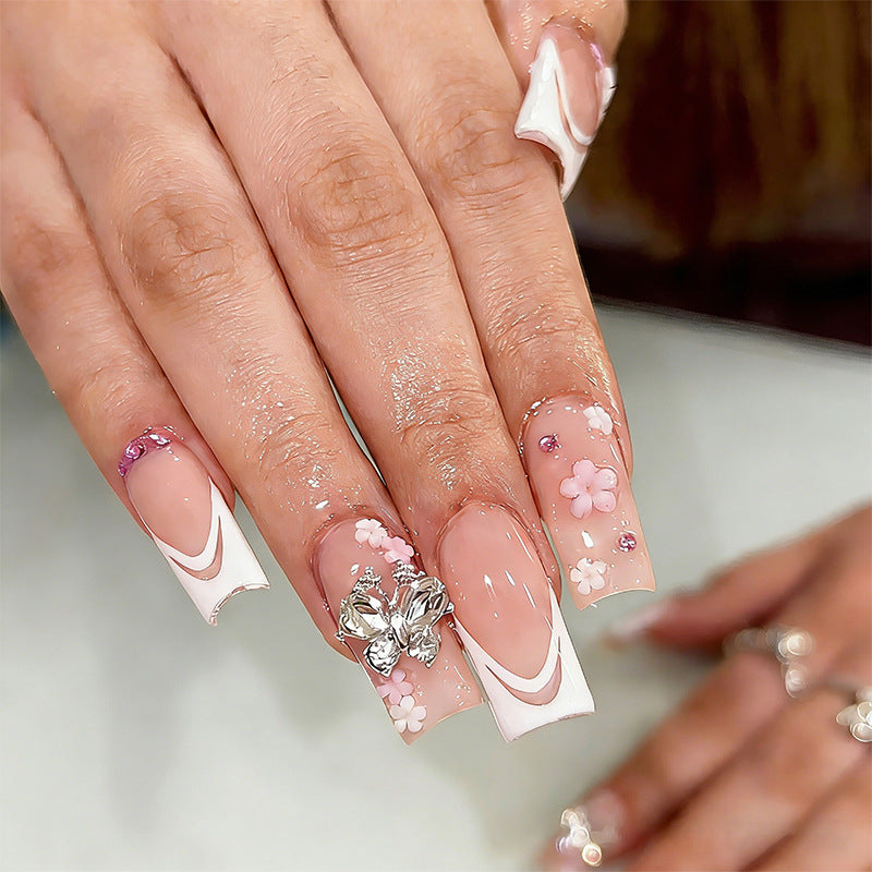 Artificial nails with floral accents and glitter effects Stornfield