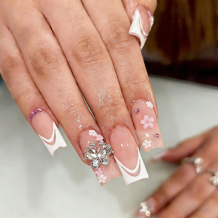 Artificial nails with floral accents and glitter effects Stornfield